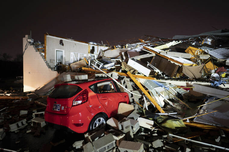 ANDREW NELLES/THE TENNESSEAN VIA AP / DEC. 9
A car is buried under rubble on Main Street after a tornado hit Hendersonville, Tenn.