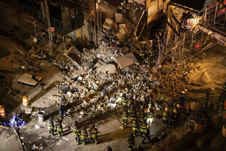 YUKI IWAMURA/AP
First responders work at the scene of a collapsed building in the Bronx borough of New York.
