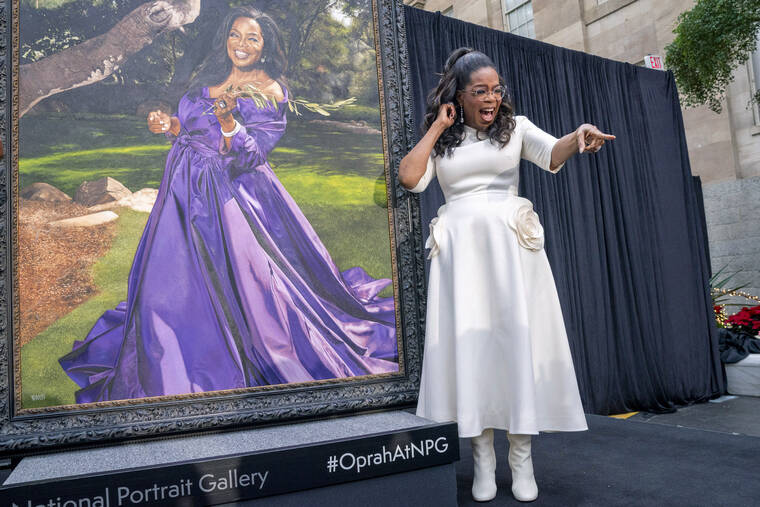 JACQUELYN MARTIN/AP
Oprah Winfrey shouts out to a member of the crowd while next to her portrait during a portrait unveiling ceremony at the Smithsonians National Portrait Gallery in Washington.