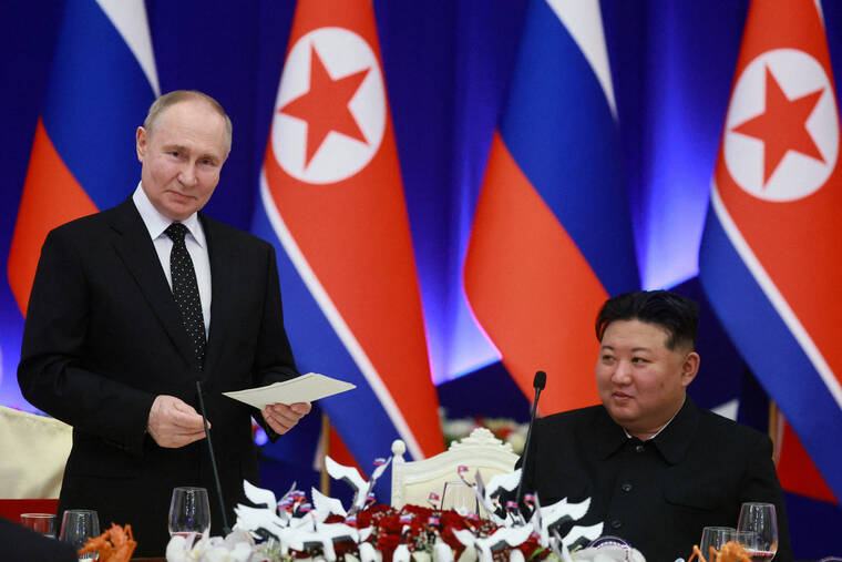 SPUTNIK/VLADIMIR SMIRNOV/POOL VIA REUTERS
Russias President Vladimir Putin and North Koreas leader Kim Jong Un attend a state reception in Pyongyang, North Korea, on June 19. Putin signed into law a treaty on the countrys strategic partnership with North Korea, which includes a mutual defense provision, according to a decree published on Saturday.