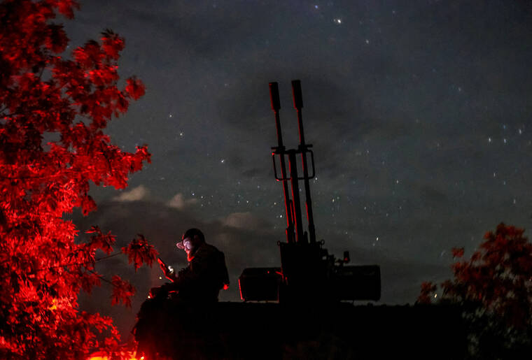 REUTERS/IVAN ANTYPENKO / JUNE 11
A Ukrainian serviceman from an anti-drone mobile air defence unit uses his mobile device near a ZU-23-2 anti aircraft cannon as he waits for Russian kamikaze drones, amid Russias attack on Ukraine, in Kherson region, Ukraine.