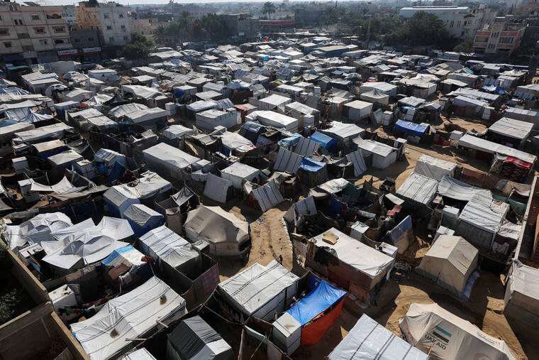 REUTERS/RAMADAN ABED
Displaced Palestinians shelter at a tent camp, amid the Israel-Hamas conflict, in Deir Al-Balah in the central Gaza Strip.
