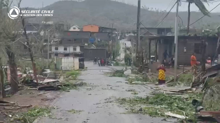 FRENCH CIVIL SECURITY/HANDOUT VIA REUTERS
Locals stand on a street covered in debris after Cyclone Chido swept through Mayotte, France in this screengrab taken from a handout video obtained by Reuters.
