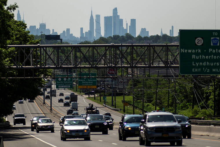 REUTERS/EDUARDO MUNOZ / MAY 24
Cars drive along a highway during the Memorial Day weekend while the New York Skyline and the Empire State Building are seen in the background in Clifton, New Jersey.