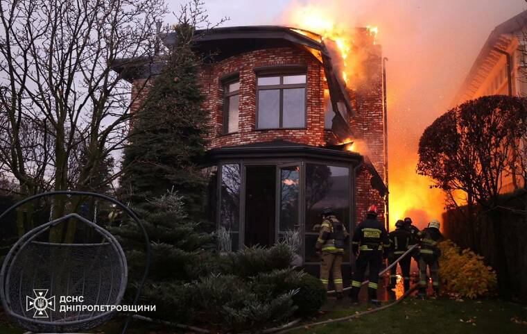 REUTERS/HANDOUT
Firefighters work at the site of a Russian missile strike in Dnipro, Ukraine, today.