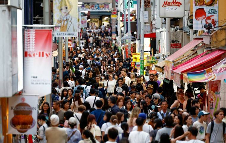 REUTERS/WILLY KURNIAWAN/FILE PHOTO
People walk along Takeshita Street at Harajuku shopping area in Tokyo, Japan, on Aug. 10. Japan set a new annual record for visitor arrivals with one month to spare, official data showed on Wednesday, as the weak yen helped propel the nations tourism boom.