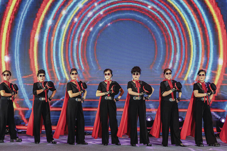 NEW YORK TIMES
Above, a group of older women performs during a fall festival at a mall in Jinan, in eastern China.