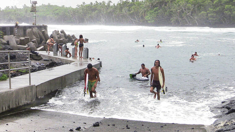STAR-ADVERTISER / 2014
Prior to the 2018 Kilauea eruption, Pohoiki Beach was a popular spot for swimmers, surfers and companies operating lava ocean tours. Surfers and onlookers enjoy the high surf at Pohoiki Beach.