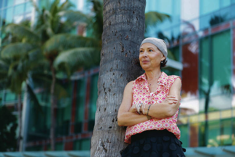 GEORGE F. LEE / GLEE@STARADVERTISER.COM
                                Susan Hirano, a patient of Dr. Naoto T. Ueno, has been battling Stage 4 metastatic breast cancer for three years. Hirano stands in front of the University of Hawaii Cancer Center, where she is a volunteer.