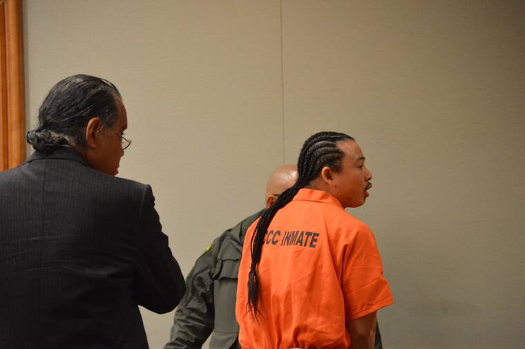 JOHN BURNETT/TRIBUNE-HERALD
Jarvis Boots turns to speak to a loved one in the gallery Friday in Hilo Circuit Court. Looking on is Boots court-appointed attorney, Stanton Oshiro.
